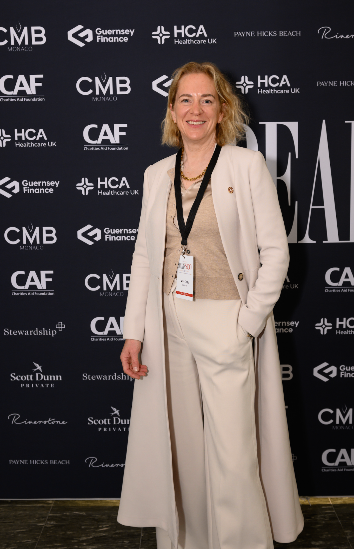 Erika Clegg at the Spear's 500 event in a long cream coat.