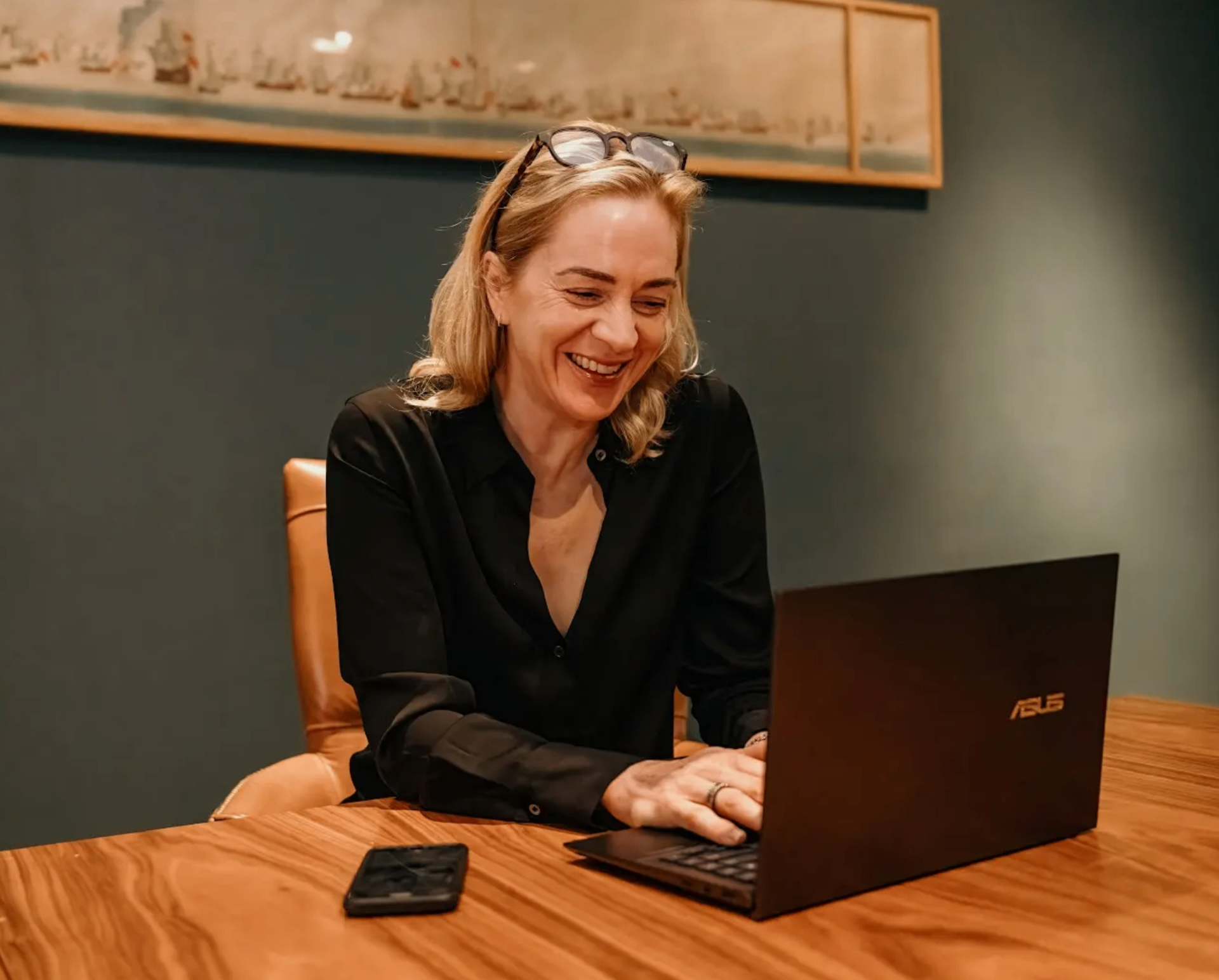 Erika Clegg working at a laptop, smiling
