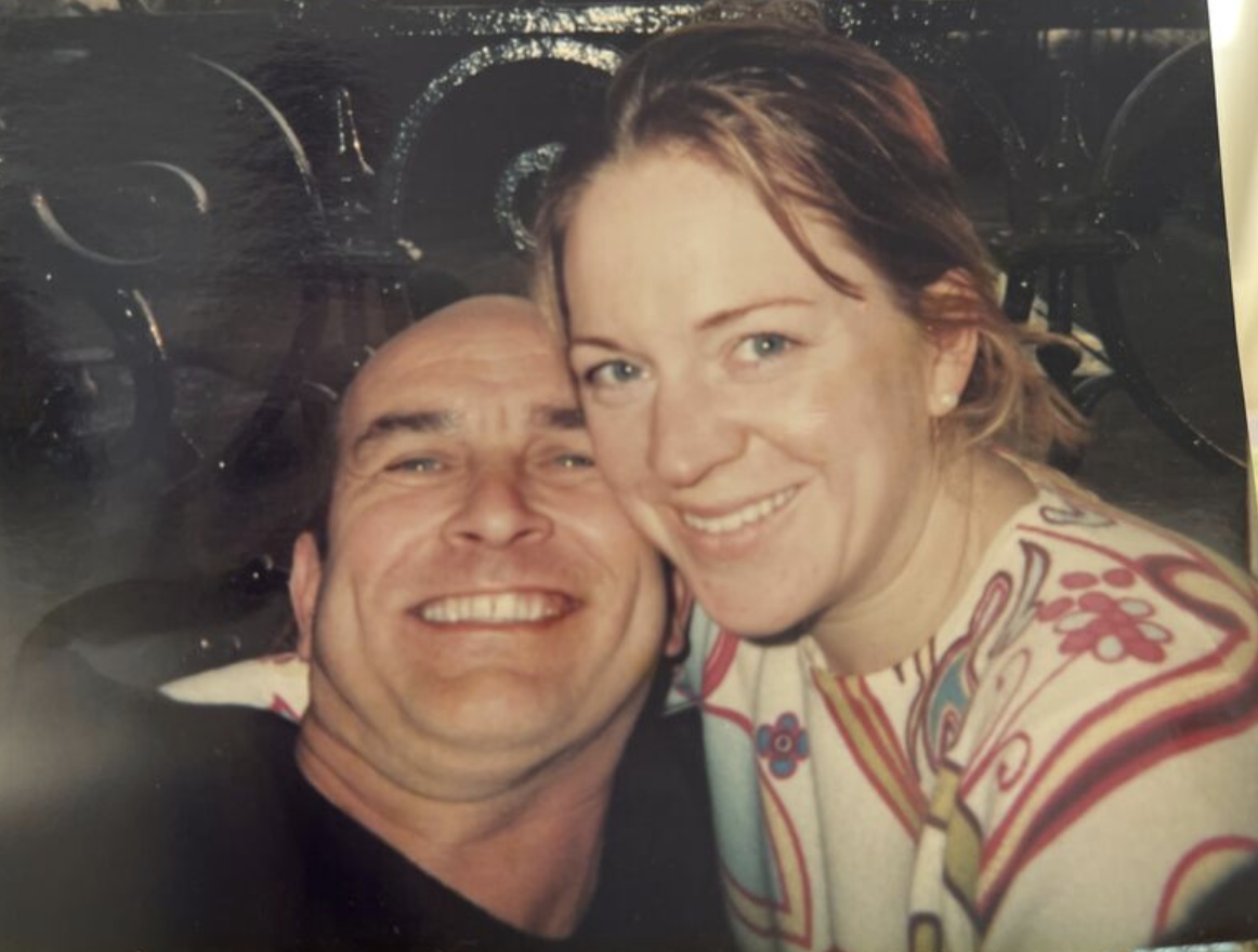Erika and her husband, smiling cheek to cheek.